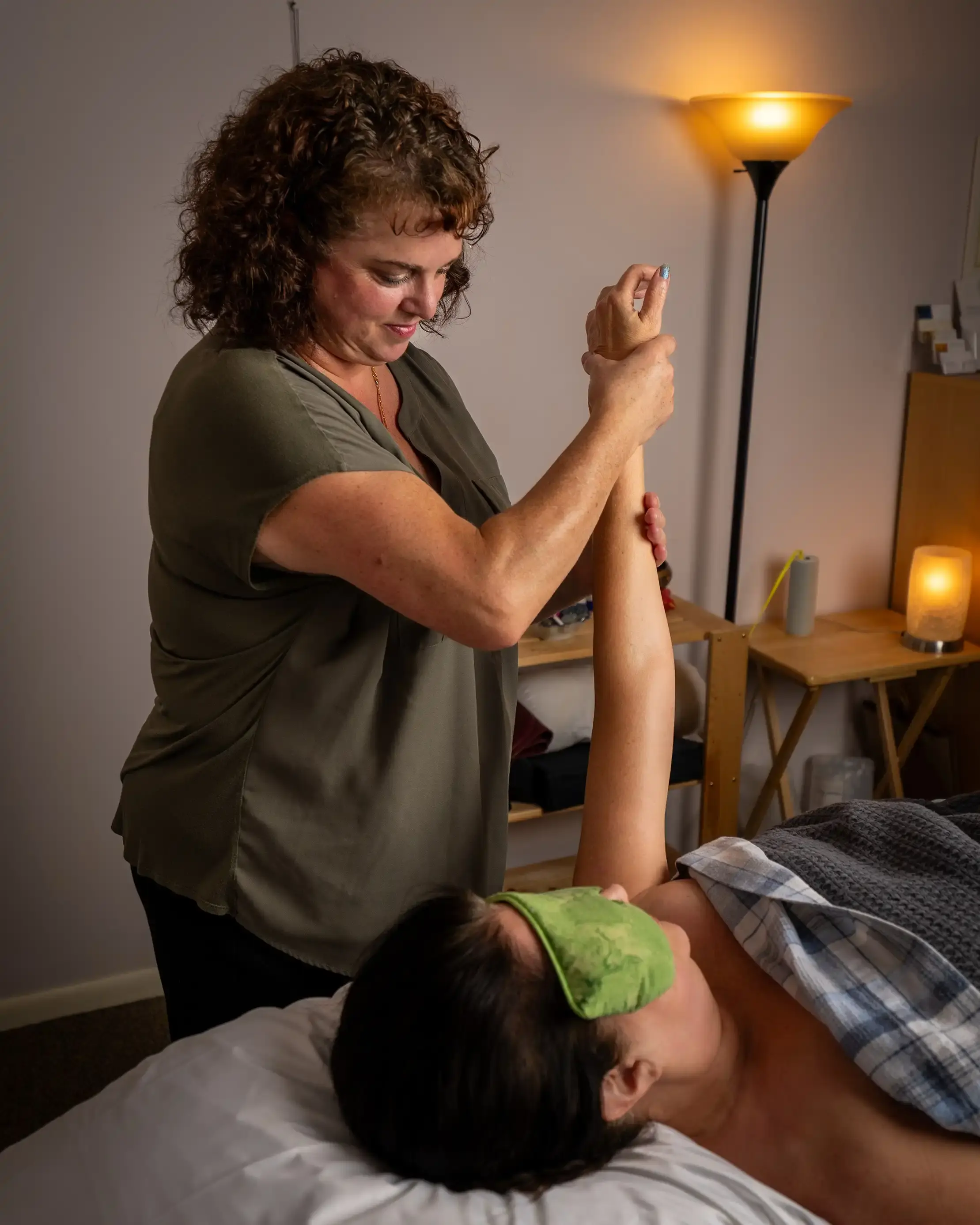 A picture of Heather massaging a client's arm