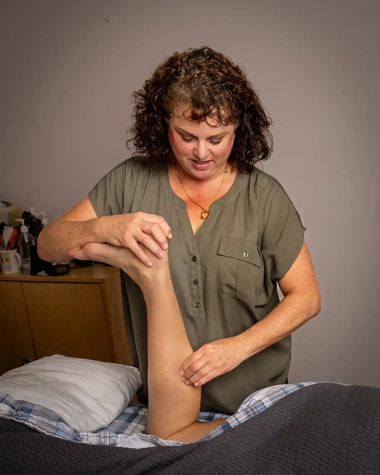 A picture of Heather massaging a client's calf